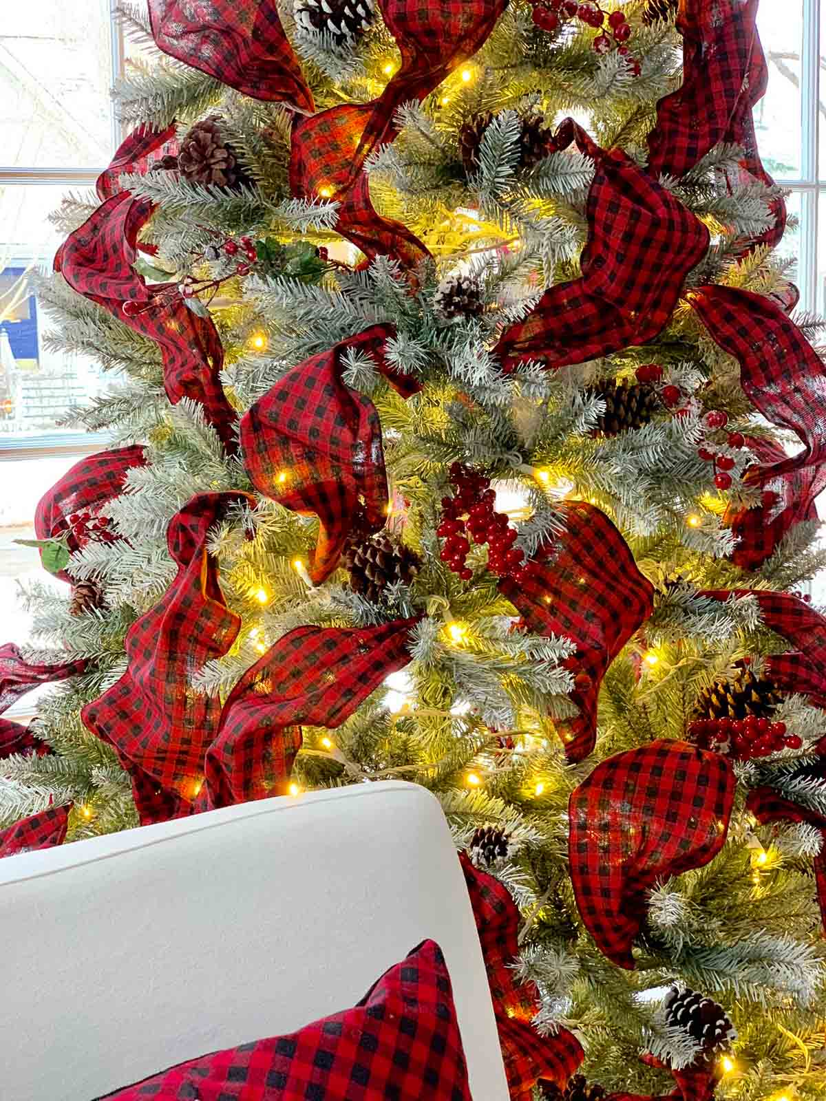 white christmas tree red ribbons white chairs red pillows #christmasdecorating #christmastree