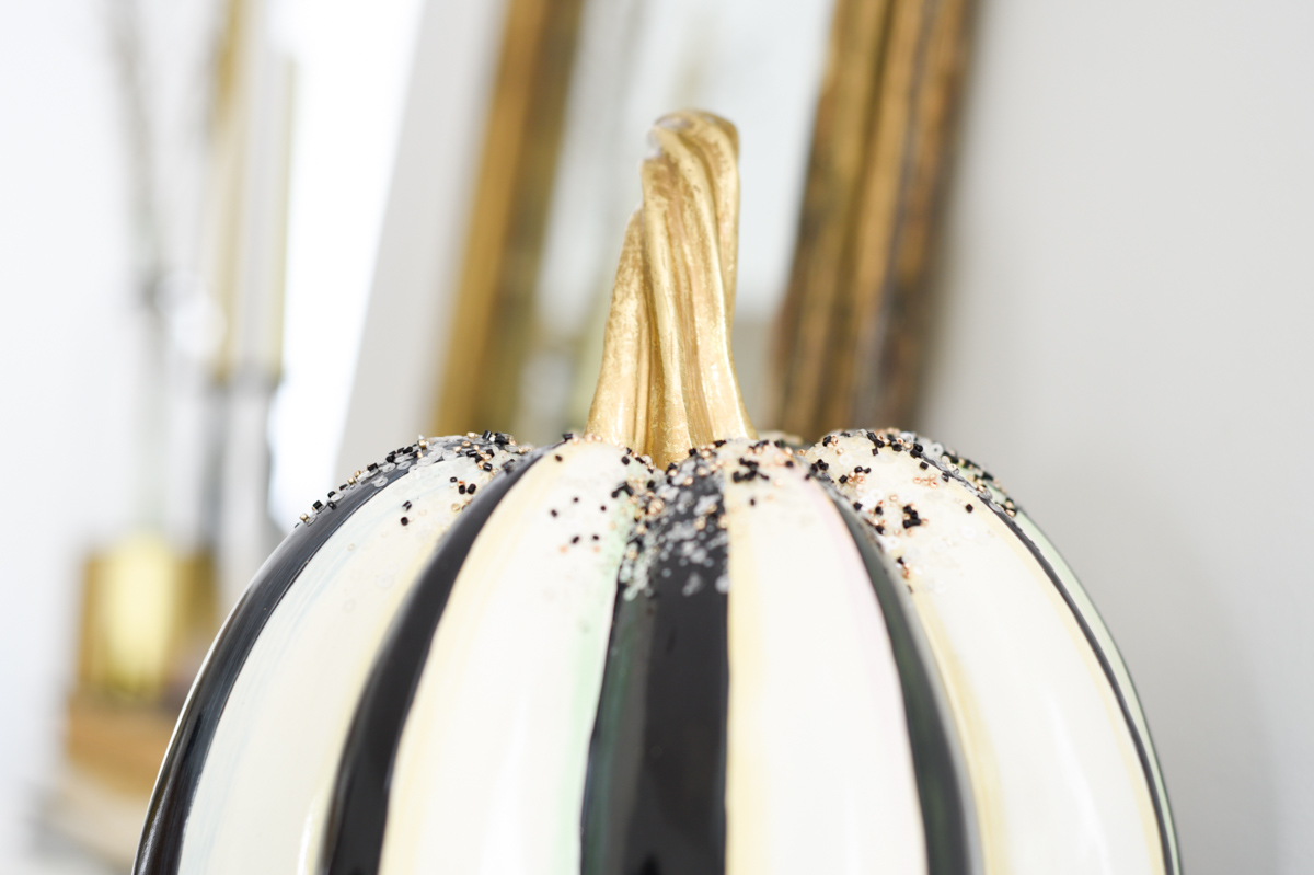 Adding small touches of Fall Halloween decor to my mantel with a black and white pumpkin from Mackenzie-Child's #fallmantel #blackandwhitepumpkins 